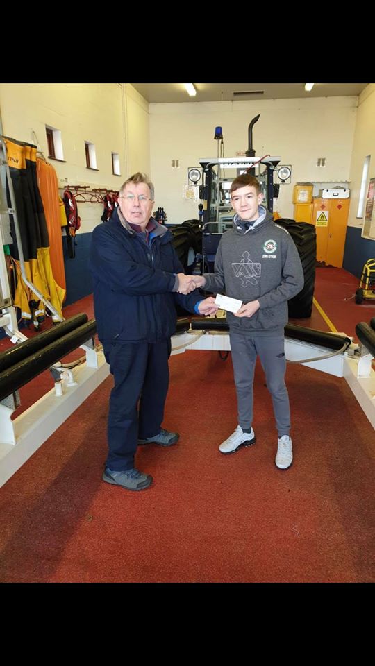 Federation youth member Lewis Kitson delivers a cheque to RNLI